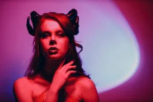 Evil woman with makeup zodiac signs of Capricorn or Aries or Taurus. Girl with horns on head.