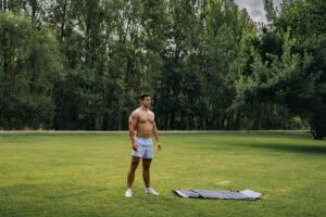 Latin fit man doing exercise in nature. Stoicism, overcoming, constance concepts. Copy space.